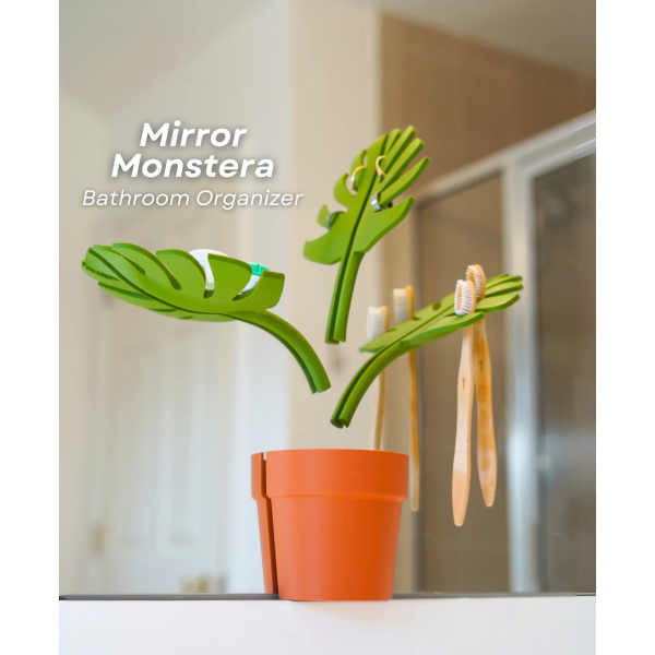 Mirror Monstera – A stylish, wall-mounted bathroom organizer with leaf-shaped holders for rings, toothbrushes, soap, and more. Saves counter space and mounts easily to a mirror.